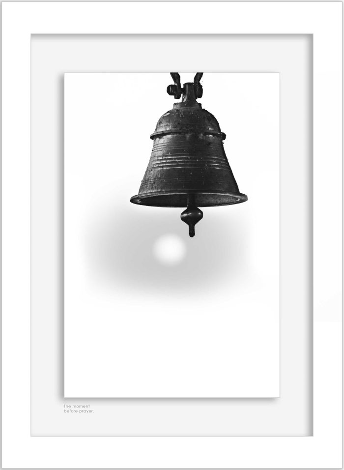 Framed black and white photograph of a hanging temple bell displayed on a wall